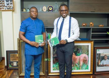 Abeiku Santana receives copies of Ecotourism Handbook from Forestry Commission CEO