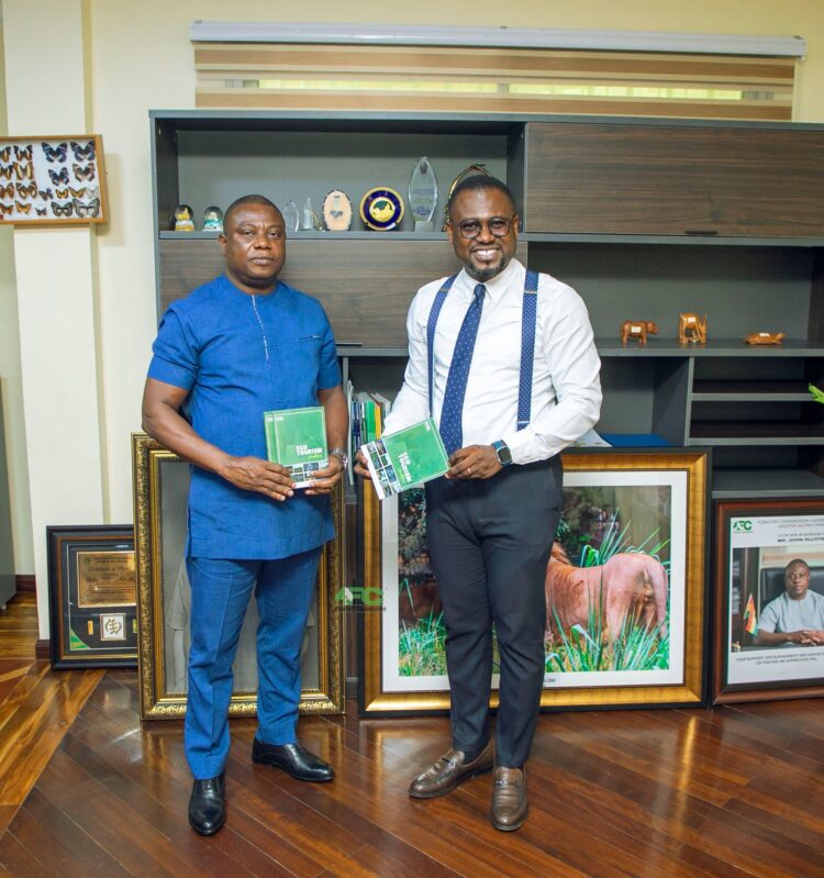 Abeiku Santana receives copies of Ecotourism Handbook from Forestry Commission CEO