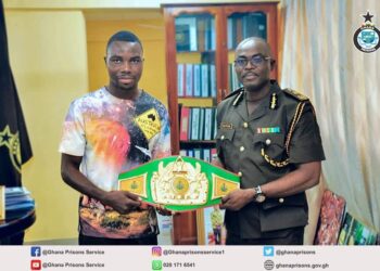 Boxer presents National Title Belt to Director General of Prisons