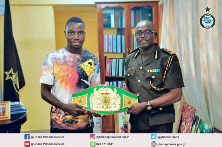 Boxer presents National Title Belt to Director General of Prisons