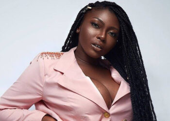 Sefa lifts shirt to expose pierced navel