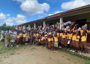 Headteacher and Staff of Gomoa Nsuaem D/A Basic School distributes free exercise books to pupils