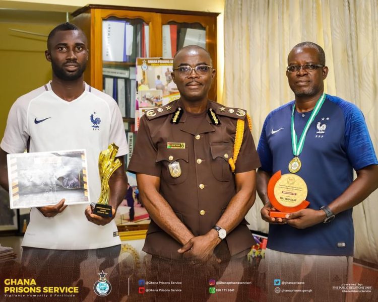 SCO. Odoi and SGT. Azameti present awards to DG of Prisons
